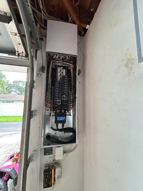 Electrical panel with breakers, wiring, and conduit installed in wall cavity