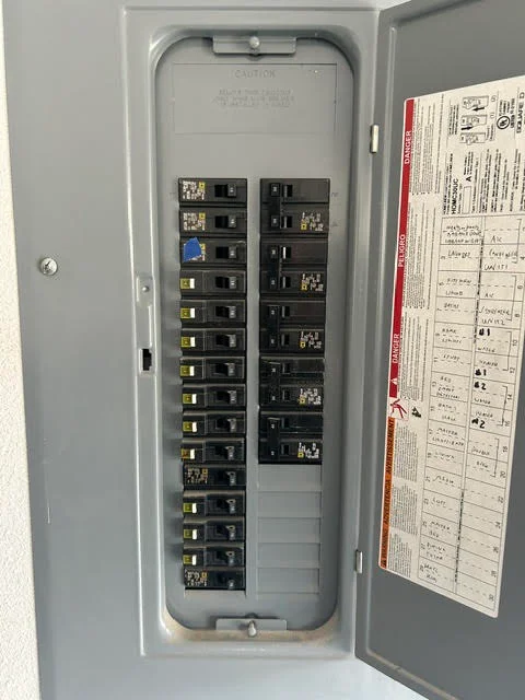 Electrical panel with dual-column breaker configuration and labeled circuit directory