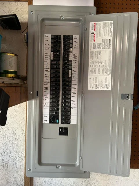 Installed electrical panel with organized breaker switches and circuit labeling