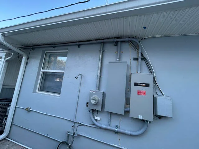 Generac generator with transfer switch and electrical panel installed on home exterior